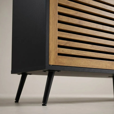 Close-up of a modern cabinet with black frame and wooden slatted door on a neutral background