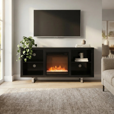 A modern black electric fireplace media console in a living room setting, featuring a glowing fire effect in the center compartment, open side shelves, and a flat-screen TV mounted above on a light gray wall.