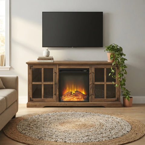 A wooden entertainment console with an integrated electric fireplace showing glowing logs, styled in a living room setting with a TV, plant, and rug.